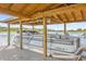 Covered boat lift with a pontoon boat at 13016 Shady Retreat Loop, Clermont, FL 34711