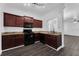 Modern kitchen with dark wood cabinets and granite countertops at 132 Vista Verdi Cir # 220, Lake Mary, FL 32746