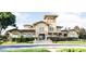 Grand community center with welcoming entryway and manicured landscaping at 132 Vista Verdi Cir # 220, Lake Mary, FL 32746