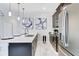 Modern kitchen with stainless steel appliances and white quartz countertops at 690 Pebble Beach Dr, Davenport, FL 33896
