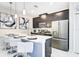 Modern kitchen with stainless steel appliances and a large island at 690 Pebble Beach Dr, Davenport, FL 33896
