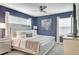Primary bedroom with a large bed and en-suite bathroom at 690 Pebble Beach Dr, Davenport, FL 33896