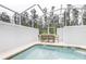 Relaxing screened-in pool area with table at 690 Pebble Beach Dr, Davenport, FL 33896