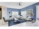 Open living area with a white sectional and blue accents at 690 Pebble Beach Dr, Davenport, FL 33896
