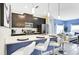 Open concept kitchen features a breakfast bar and modern cabinetry at 690 Pebble Beach Dr, Davenport, FL 33896