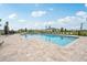 Inviting community pool with plenty of lounge chairs and a large deck at 1242 Normandy Dr, Haines City, FL 33844