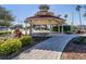 Quaint gazebo with brick pathway and landscaping at 1242 Normandy Dr, Haines City, FL 33844