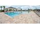 Community pool with spacious deck and shaded seating area at 1242 Normandy Dr, Haines City, FL 33844