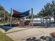 playground with shade structure and play equipment at 1242 Normandy Dr, Haines City, FL 33844