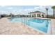 Community pool with spacious deck, shaded seating area, and nearby playground at 1242 Normandy Dr, Haines City, FL 33844