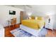 Bedroom with a queen-size bed, hardwood floors, and a desk at 17833 Woodcrest Way, Clermont, FL 34714