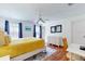 Well-lit bedroom with a queen bed, hardwood floors, and a work area at 17833 Woodcrest Way, Clermont, FL 34714