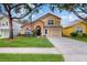 Two story house with front yard and driveway at 17833 Woodcrest Way, Clermont, FL 34714