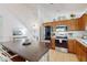 Bright kitchen features stainless steel appliances and an island with seating at 17833 Woodcrest Way, Clermont, FL 34714