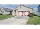 Single story home with attached garage and manicured lawn at 3690 Maidencain St, Clermont, FL 34714