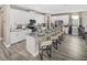 Modern kitchen featuring white cabinets, granite countertops, and a large island at 9179 Breeze Mist Ter, Kissimmee, FL 34747