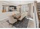 Elegant dining room with wood table, neutral decor, and adjacent kitchen at 9179 Breeze Mist Ter, Kissimmee, FL 34747