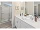 Modern bathroom with double vanity and shower at 9179 Breeze Mist Ter, Kissimmee, FL 34747