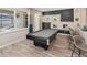 Game room with pool table, bar seating, and backyard access at 9179 Breeze Mist Ter, Kissimmee, FL 34747