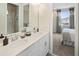 Double vanity bathroom with a view into a bedroom at 9179 Breeze Mist Ter, Kissimmee, FL 34747