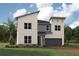 Two-story modern home with light colored exterior and gray garage door at 9179 Breeze Mist Ter, Kissimmee, FL 34747