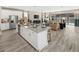 Open concept kitchen with island seating and views into the living room at 9179 Breeze Mist Ter, Kissimmee, FL 34747