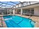 Inviting screened-in pool with spa and patio furniture at 9179 Breeze Mist Ter, Kissimmee, FL 34747