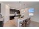 Modern kitchen with dark cabinetry, granite countertops, and island at 12783 Trovita Dr, Grand Island, FL 32735