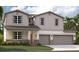 Two-story home with stone accents and two-car garage at 12783 Trovita Dr, Grand Island, FL 32735