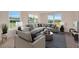 Relaxing living room with comfortable sectional sofa and large windows at 12783 Trovita Dr, Grand Island, FL 32735