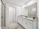 Modern bathroom with double vanity and walk-in shower at 12783 Trovita Dr, Grand Island, FL 32735