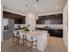 Well-equipped kitchen with dark wood cabinets and granite island at 12783 Trovita Dr, Grand Island, FL 32735
