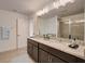 Double vanity bathroom with granite countertops and a walk-in shower at 12783 Trovita Dr, Grand Island, FL 32735