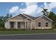 Single-story home with gray siding, white trim, and a covered porch at 2564 Hawks Overlook Pl, Oviedo, FL 32765