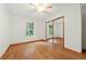 Bright bedroom featuring wood flooring and a mirrored closet at 1150 Woodchuck Ct, Orange City, FL 32763