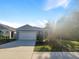House exterior with driveway and two-car garage at 309 Gina Ln, Davenport, FL 33837
