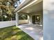 Covered patio with sliding glass doors and fenced backyard at 309 Gina Ln, Davenport, FL 33837
