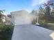 House exterior with driveway and two-car garage at 309 Gina Ln, Davenport, FL 33837