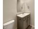 Bathroom with vanity, toilet, and a large mirror at 309 Gina Ln, Davenport, FL 33837