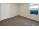 Spacious bedroom with neutral carpeting and a window at 309 Gina Ln, Davenport, FL 33837