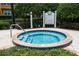 Relaxing community hot tub with safety rules posted at 7582 Assembly Ln, Reunion, FL 34747