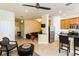 Open living area features a comfortable seating arrangement and flows into kitchen at 7582 Assembly Ln, Reunion, FL 34747