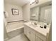 Elegant bathroom with a soaking tub and a walk-in shower at 7582 Assembly Ln, Reunion, FL 34747