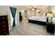 Spacious main bedroom with a king-size bed and access to a private balcony at 7582 Assembly Ln, Reunion, FL 34747