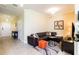 Living room with leather sectional sofa and decorative accents at 7582 Assembly Ln, Reunion, FL 34747