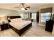 King sized bed, large window and ceiling fan in spacious bedroom at 7582 Assembly Ln, Reunion, FL 34747