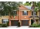 Two-story townhouse with attached garage and landscaping at 7582 Assembly Ln, Reunion, FL 34747
