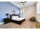 Spacious main bedroom with king-size bed, wood floors, and plenty of natural light at 1169 Castle Pines Ct, Reunion, FL 34747