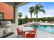Inviting pool area with built-in spa, outdoor kitchen, and comfortable seating at 1169 Castle Pines Ct, Reunion, FL 34747