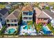 Aerial view of a luxury home with a private pool and spa, surrounded by other homes at 1169 Castle Pines Ct, Reunion, FL 34747